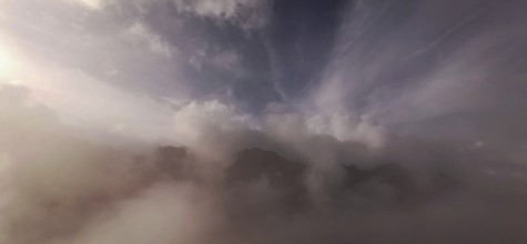 Gentle fog and cloud formations over a mountain landscape at dusk, hiking in the High Tatras