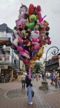 Large group of colorful balloons in the form of comic figures, children's toys on a road, Zakopane,