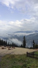 Panoramic view from a viewpoint on Mount Gubalowka with clouds, mountains and a town in the valley,