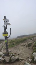 Rocky trail with signposts and fog landscape, Zakopane, hiking to Kasprowy Wierch in the High