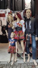 Three dolls in traditional, folkloric clothing with floral patterns in a shop window, Zakopane,