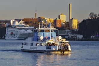 A ferry in daylight with an urban skyline in the background, Stockholm, Djurgarden, Sweden,