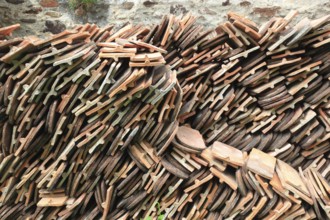 Old roof tiles stored on stockpiles for reuse on historic buildings and heritage-protected houses,