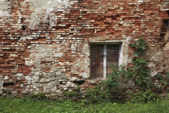 Dilapidated house wall with window, built with brick, Transylvania, Romania
