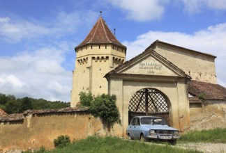 The fortified church of Seica Mica, German Kleinschelken, in front of it a Daccia 1300, a community