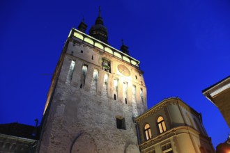 Romania, hour tower at the blue hour in the historic old town of Sighisoara, German Sighisoara,