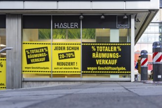 Clearance sale in the city center. A shoe store offers discounts on sales. Stuttgart,