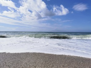 Roaring ocean waves on the beach under a clear blue sky, Dhermi, Albanian Riviera, Albania