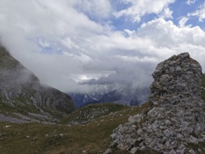 Dramatic mountain scene with fog covered peaks and lonely rock structure, Peaks of the Balkans,