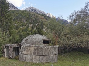 Concrete bunker in a wooded mountainous landscape, a relic from the past, Hoxha, dictatorship,