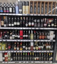 Shelf full of various port wines, wine bottles and spirits in a shop, Lagos, Algarve, Portugal