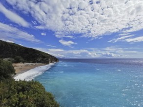 Panoramic view of a beach with turquoise sea and spectacular cloud patterns, Gjipe Beach, Albania