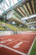 Sports hall with red running track and green seats in the stands, Sindelfingen Glass Palace,