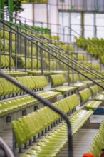 Detailed view of green seats and railings of a sports hall gallery, Sindelfingen Glass Palace,