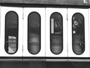 Monochrome photo of the windows of a nostalgic wagon on a steam locomotive, Rosen, Germany