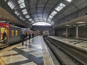 A modern train station with open roofs where trains arrive and people travel, Lisbon railway