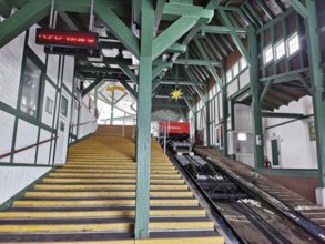 Large mountain station in wooden design with yellow stairs leads to the cable car, Oberweissbach