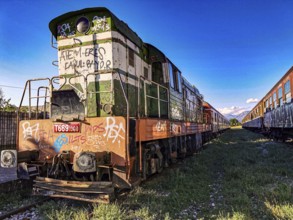 Colorful locomotive with graffiti in the sun on abandoned tracks, Albania