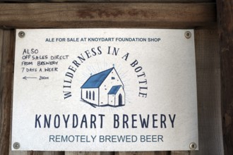 Brewery sign with stylized house and text about ale sales in the Knoydart region, Highlands,
