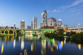 Tampa skyline with skyscrapers and bridge over Hillsborough River at night in downtown Tampa, USA