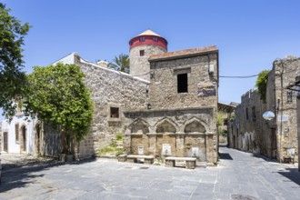 Ottoman fountain and windmill in the historic old town from the Middle Ages on the island of
