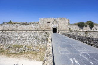 Red gate from the Middle Ages in the city wall of the historic old town on the island of Rhodes,