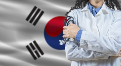 Healthcare professional with South Korea flag background. Professional doctor holding stethoscope