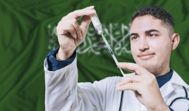 Doctor holding syringe on Saudi Arabia flag background. Medical professional holding syringe with