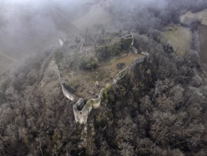 Aerial view of the ruins of Mägdeberg Castle in Hegau on a foggy winter day, Mühlhausen-Ehingen,
