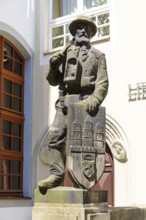 Bergmannsdenkmal, sandstone figure of a miner with coat of arms, behind the town hall in Freiberg,