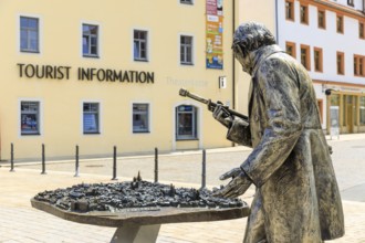 Silver figure explorer traveling by Ekaterina Kovalenko on Castle Square with bronze model of the