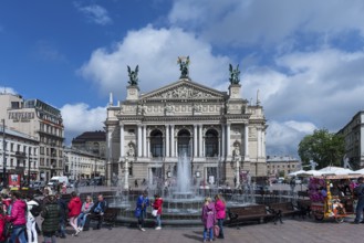 Hustle and bustle at the Opera Fountain, the Opera House in the back, Lviv, Ukraine