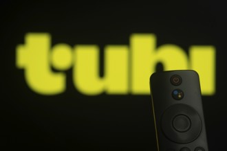 Dhaka, Bangladesh- 21 Jan 2026: Close-up of a smart TV remote control against a blurred tubi logo
