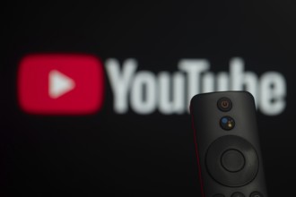 Dhaka, Bangladesh- 21 Jan 2026: Close-up of a smart TV remote control against a blurred youtube
