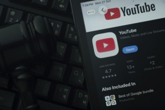 Dhaka, Bangladesh- 28 Oct 2025: An iPad displaying the youtube app against a judge's gavel and dark