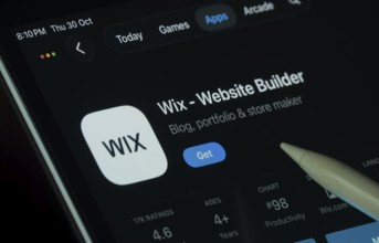Dhaka, Bangladesh- 30 Oct 2025: Wix app displayed on a iPad screen in dark mode with a digital pen