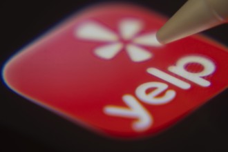 Dhaka, Bangladesh- 06 Dec 2025: Close-up of the Yelp app on a screen with a stylus pointing at it