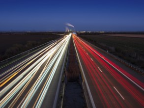 Night shot, long exposure, light trails on the A38 motorway, Schkopau power plant in the back,