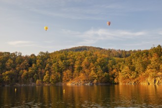 Hot air balloons over the Brno Reservoir (Brnenská prehrada) on the Svratka River on a sunny autumn
