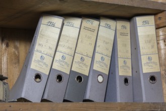 Shelves with dusty folders in the administration of a former GDR factory, Lost Place,