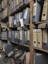 Shelves with dusty folders in the administration of a former GDR factory, Lost Place,