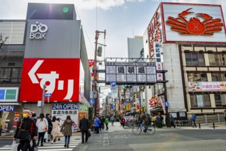 Lots of colorful signs in a pedestrian zone with shops and restaurants, Dotonbori, Osaka, Japan
