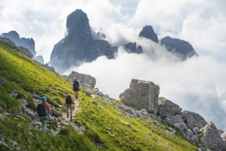 Climbers on a hiking trail, rocky mountain landscape with fog, Via Ferrata SOSAT via ferrata,