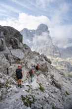 Three mountaineers on a hiking trail, rocky mountain landscape, Via Ferrata SOSAT via ferrata,