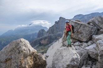 Female mountaineer on a hiking trail, rocky mountain landscape, Via Ferrata SOSAT via ferrata,