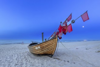 Traditional wooden fishing boat on the beach along the Baltic Sea at Stubbenfelde, Loddin on the