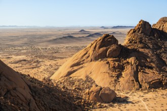 Wide desert landscape with rocks shining under bright sunlight, Spitzkoppe, Namibia
