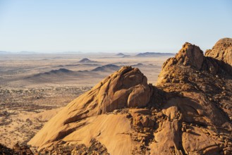 Mountain massif in the dry expanse of the desert under clear skies, Spitzkoppe, Namibia