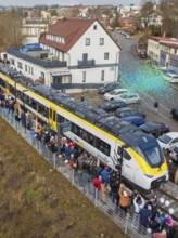 Train surrounded by a crowd in an urban area, aerial view, opening of the Hermann Hesse Railway,