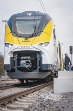 Close-up of a modern locomotive on rails under grey skies, opening of the Hermann Hesse Railway,